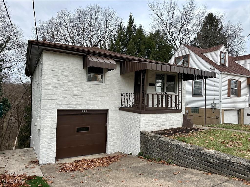 view of front of home with a porch and a garage