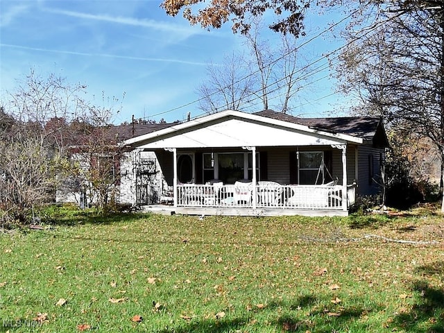 view of front of property with covered porch and a front yard