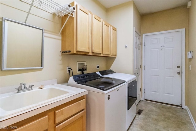 washroom featuring washer and clothes dryer, sink, and cabinets