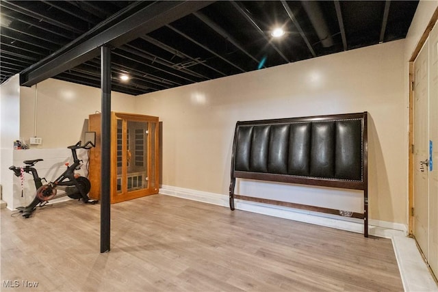 basement with hardwood / wood-style floors