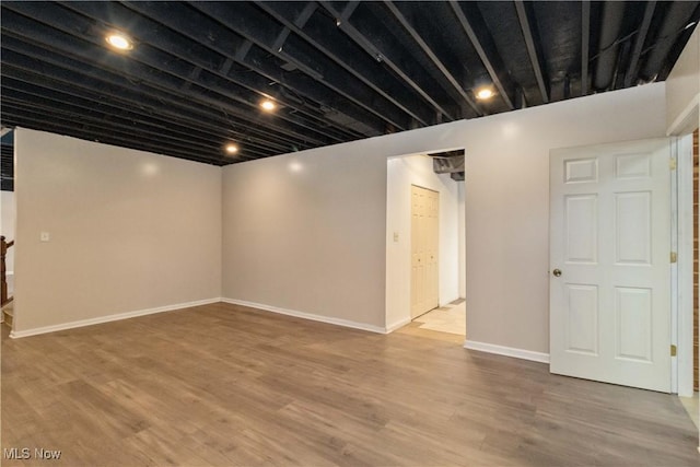 basement with hardwood / wood-style flooring