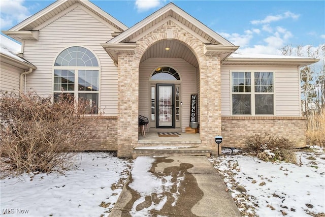 view of snow covered property entrance