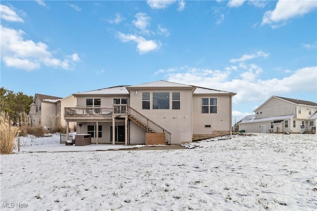 snow covered property with a wooden deck