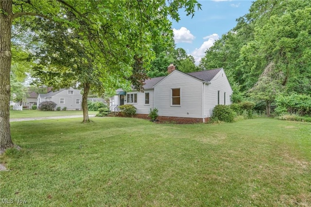 view of side of property with a lawn