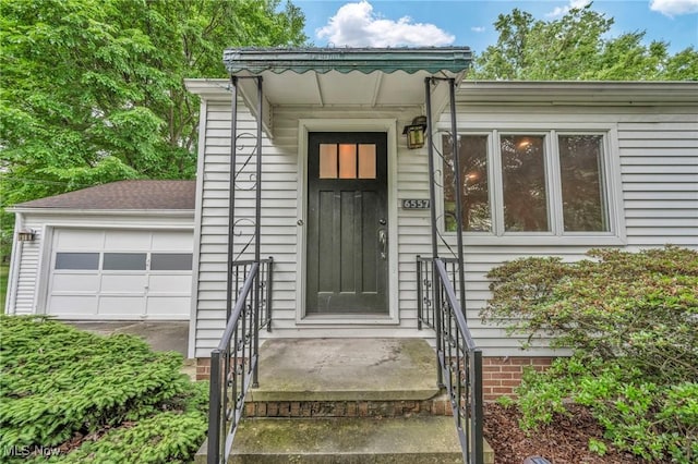 doorway to property with a garage