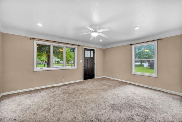 unfurnished room with ceiling fan and carpet floors