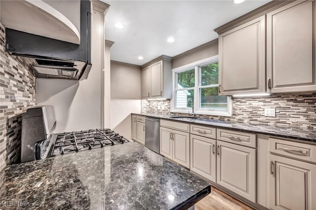 kitchen with dishwasher, dark stone countertops, sink, and tasteful backsplash