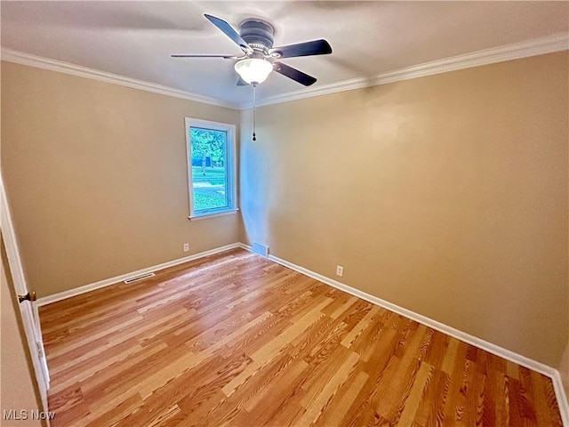 unfurnished room featuring ceiling fan, light hardwood / wood-style floors, and ornamental molding