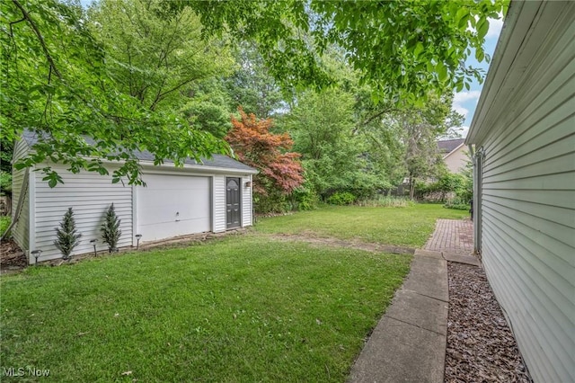 view of yard with a garage and an outdoor structure