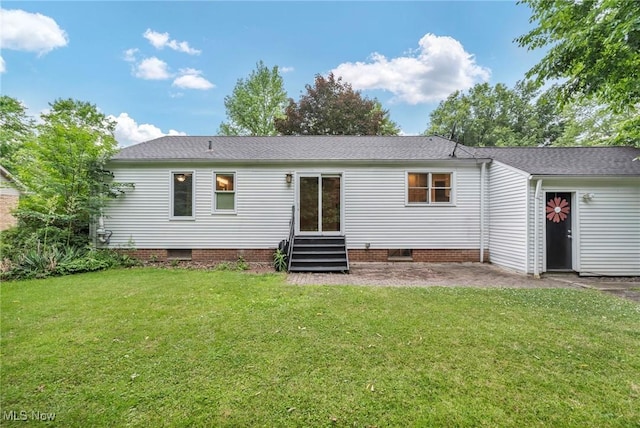 back of property with a patio and a lawn