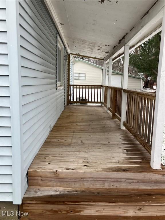 wooden terrace featuring covered porch