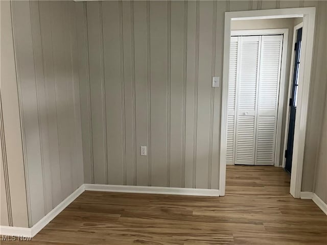 unfurnished room with hardwood / wood-style flooring