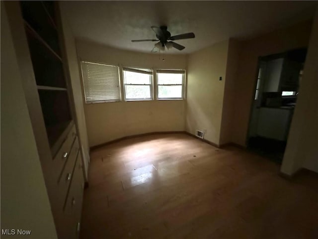 unfurnished bedroom featuring hardwood / wood-style flooring and ceiling fan