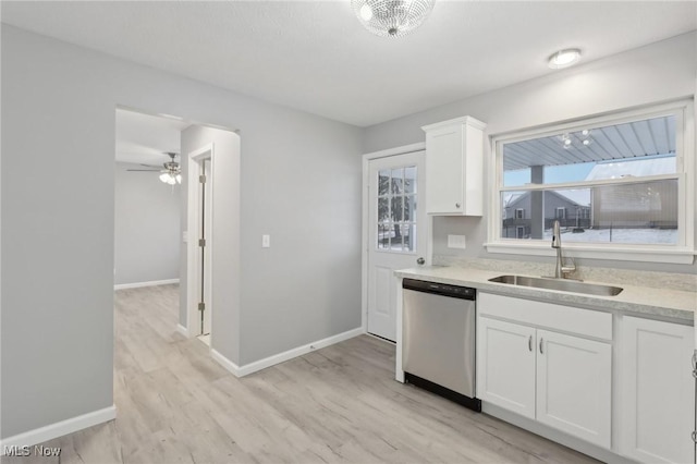 kitchen featuring stainless steel dishwasher, ceiling fan, sink, white cabinets, and light hardwood / wood-style floors