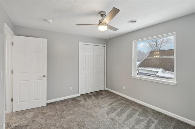 unfurnished bedroom with a closet, ceiling fan, and light colored carpet