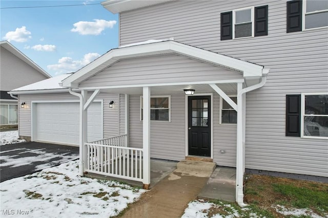 view of front facade featuring a porch and a garage