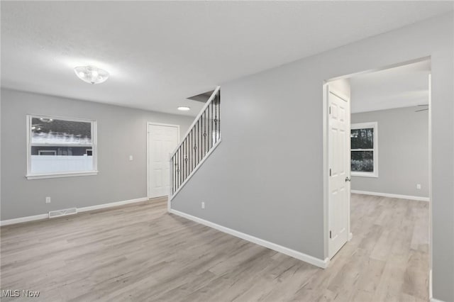 unfurnished room with light wood-type flooring