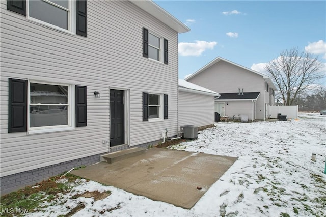 view of snow covered back of property