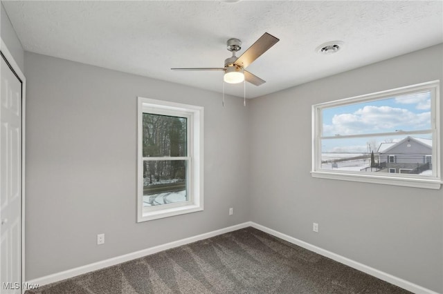 carpeted empty room with ceiling fan