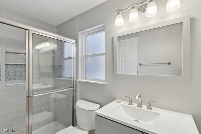 bathroom with vanity, toilet, and an enclosed shower