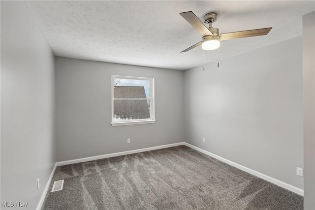 empty room featuring carpet flooring, ceiling fan, and a textured ceiling