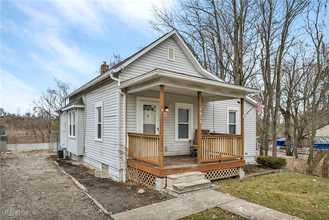 bungalow-style house with cooling unit and a porch