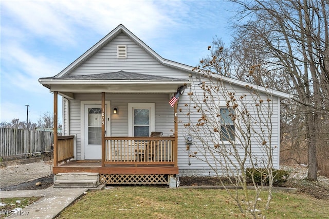 bungalow-style home with a porch and a front yard