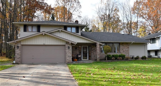 tri-level home with a front yard, central AC, and a garage