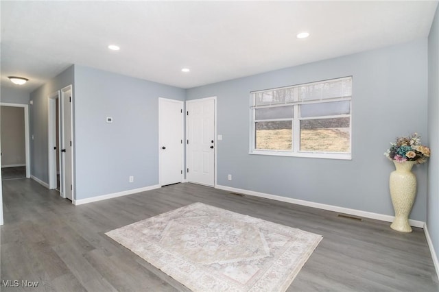 empty room featuring dark hardwood / wood-style flooring