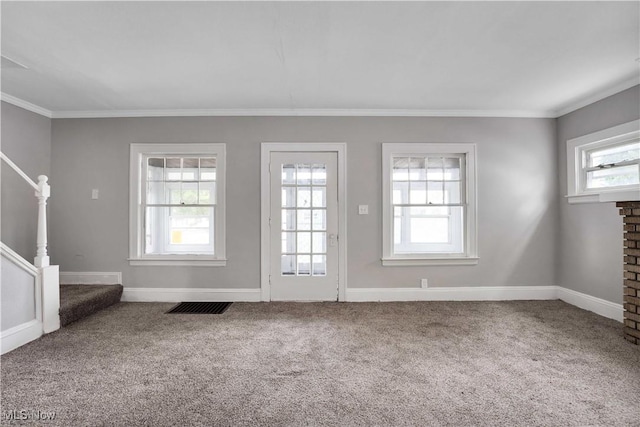 unfurnished living room with carpet, a fireplace, and crown molding