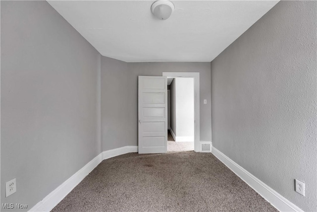 empty room with carpet flooring