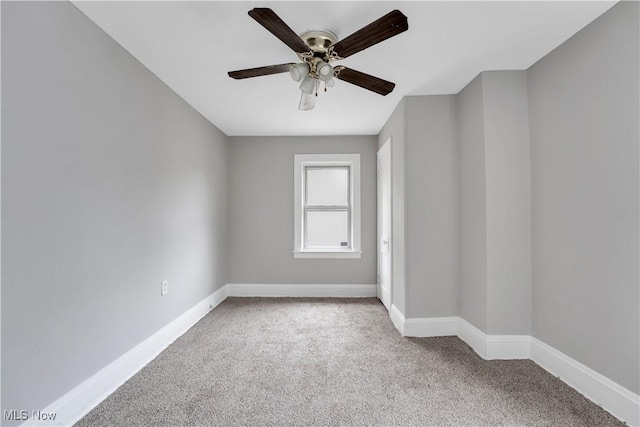 unfurnished room with ceiling fan and light carpet