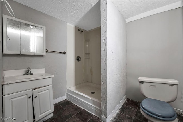 bathroom featuring walk in shower, vanity, a textured ceiling, and toilet