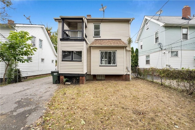 back of house with a balcony