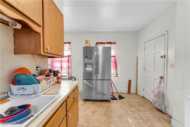 kitchen featuring stainless steel refrigerator with ice dispenser, plenty of natural light, and sink