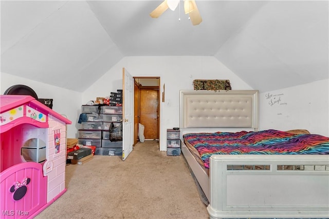 bedroom featuring light colored carpet, vaulted ceiling, and ceiling fan