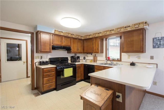 kitchen featuring black appliances, a kitchen breakfast bar, kitchen peninsula, and sink