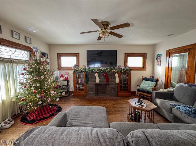 living room with dark hardwood / wood-style flooring and ceiling fan