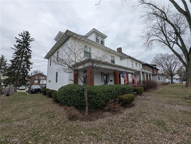 view of property exterior with a lawn and a porch