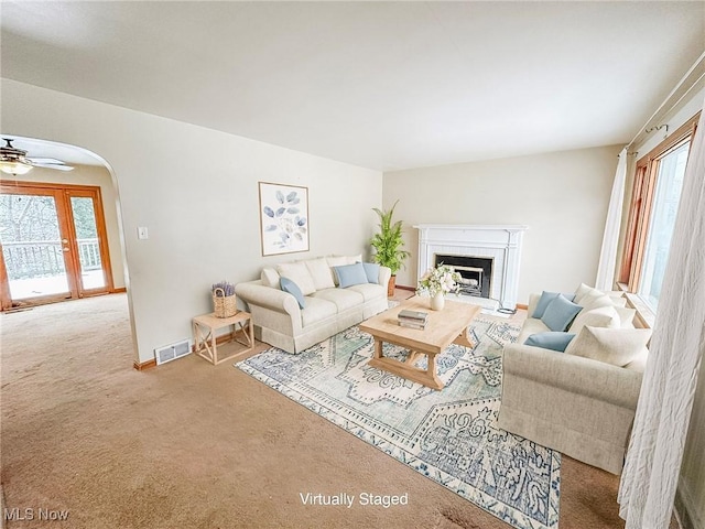 carpeted living room featuring ceiling fan