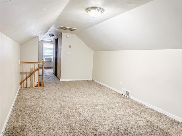 additional living space with cooling unit, carpet floors, and vaulted ceiling