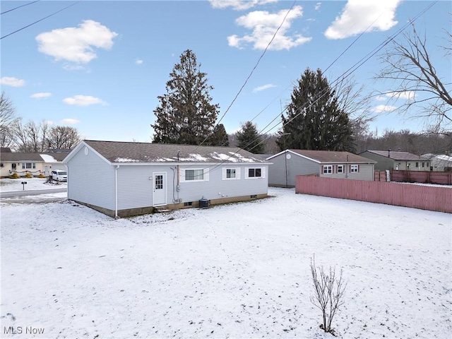 view of snow covered back of property