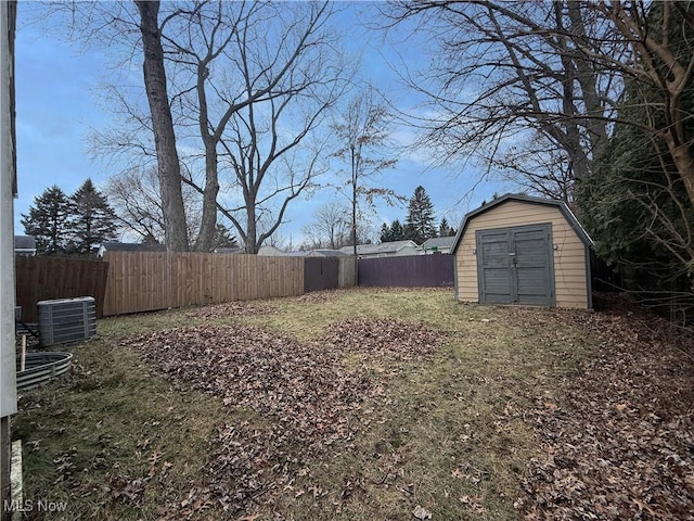 view of yard featuring central AC unit and a storage unit