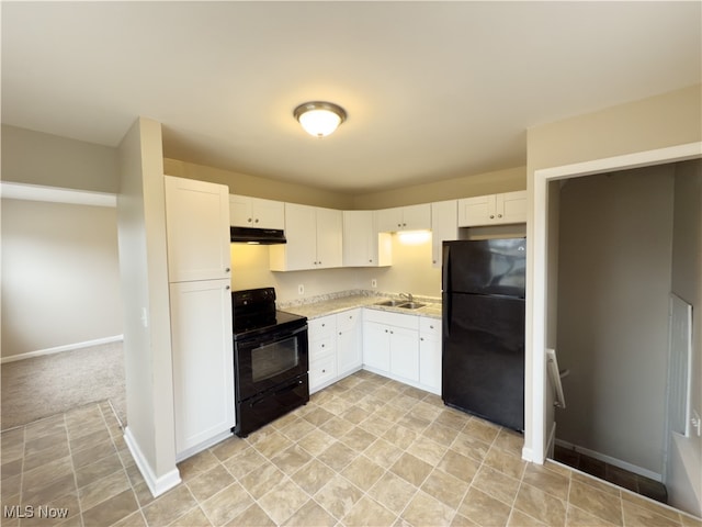 kitchen with black appliances, white cabinets, sink, and light carpet