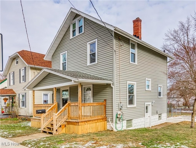 rear view of property with a porch and a yard