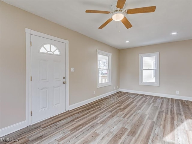 foyer entrance featuring light wood-type flooring and ceiling fan