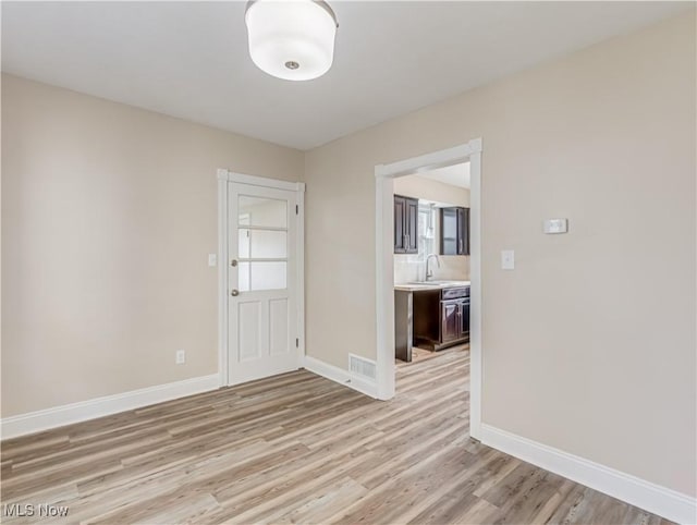 interior space featuring sink and light wood-type flooring