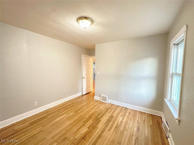 spare room featuring plenty of natural light and light wood-type flooring