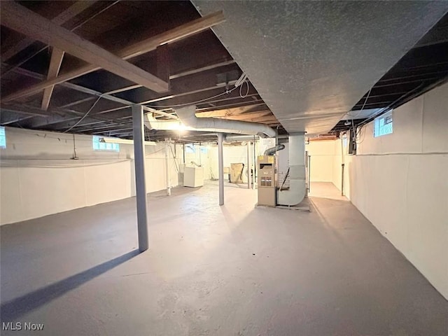 basement with washer / dryer and heating unit