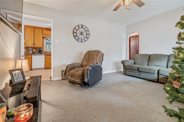 living room with ceiling fan and light colored carpet